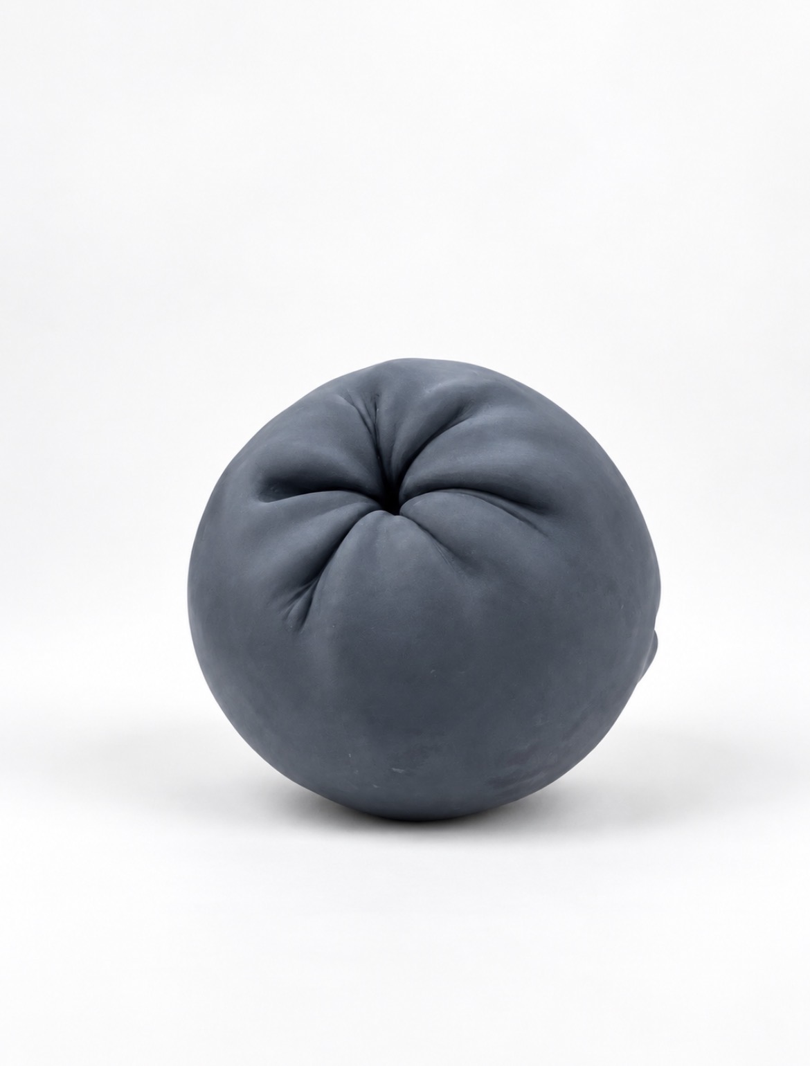 Belgian black marble sculpture by Miriam Gallardo, contemporary spherical organic form with folded texture, front view
